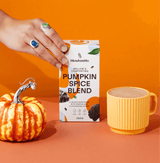 Pumpkin Spice Blend packaging with a small pumpkin and a mug of spiced drink against an orange background.