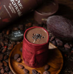 Pure Ceremonial cacao packaging with a rich brown design, featuring celestial gold details and spiritual hand illustrations.