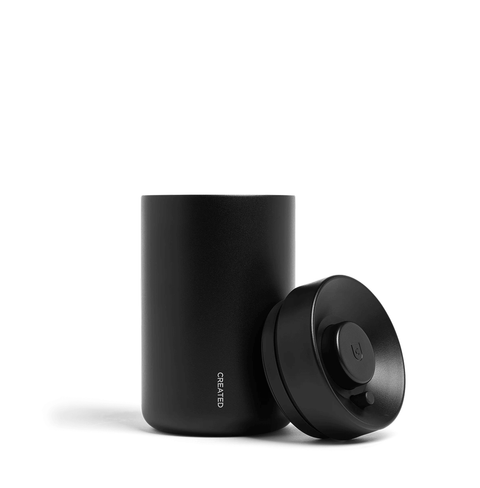 Reserve Vacuum Coffee Canister in sleek black design for preservation of coffee flavor and aroma.
