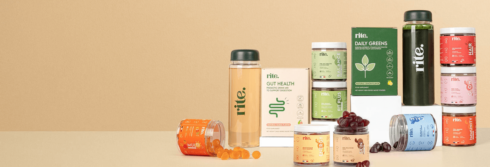 Variety of health supplements and drinks by Rite, including gut health products and daily greens, on a beige background.