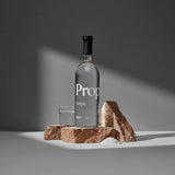 Bottle of Simple Syrup placed on a stone display, showcasing a pure and natural sweetening option.
