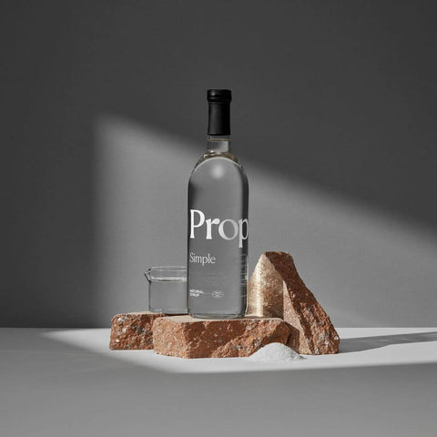 Bottle of Simple Syrup placed on a stone display, showcasing a pure and natural sweetening option.