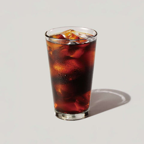 Glass of iced cold brew coffee made from Sofe Premium Cold Brew Coffee Bags Panama Geisha, showcasing rich, smooth, fruity flavors.