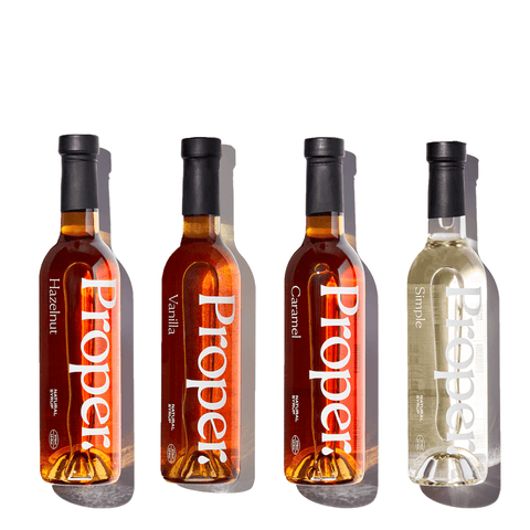 Starter Kit of flavored syrups including Hazelnut, Vanilla, Caramel, and Simple for coffee making.