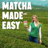 A pouch of Perfected Matcha Strawberry Matcha Powder with a whisk and a prepared matcha latte. — view 3