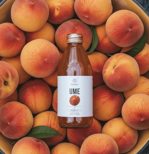 Bottle of Kimino Ume Sparkling Juice surrounded by fresh hand-picked Japanese plums.
