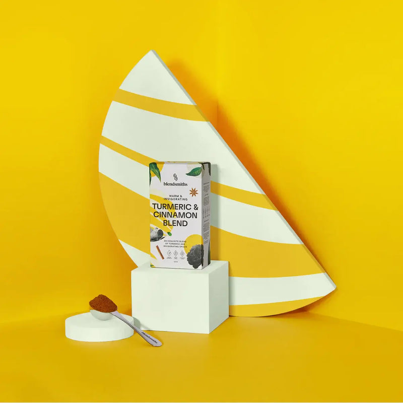 Blendsmiths Turmeric & Cinnamon Blend packaging, featuring a warm and invigorating premium drink made with turmeric and spices. The 250g box design incorporates earthy yellow tones, botanical illustrations, and spice elements like cinnamon and star anise.