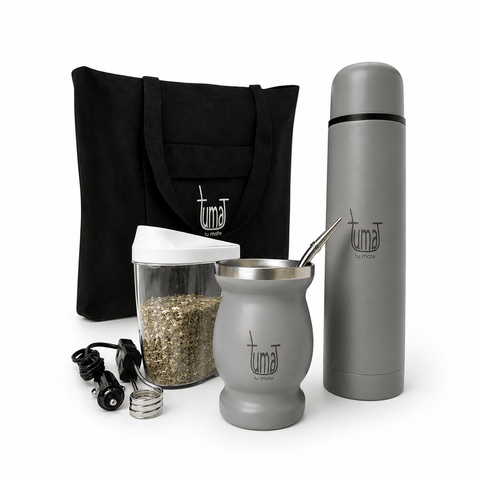 Tuma tea-making kit with tote bag, thermos, glass jar, and accessories on a gray background